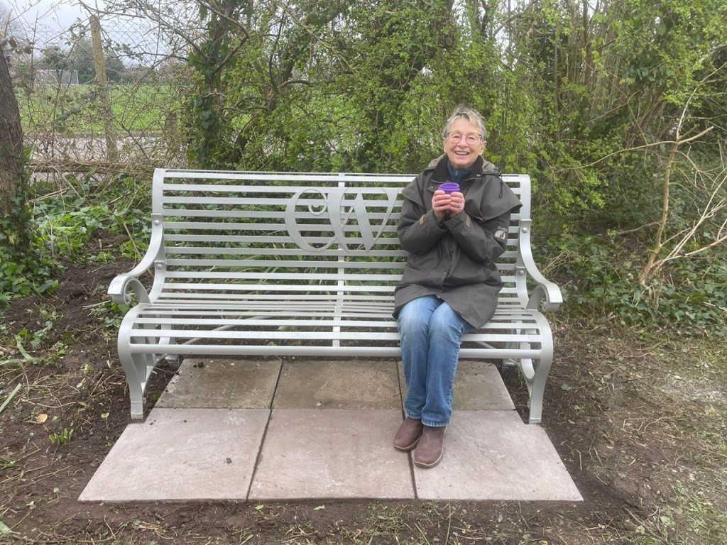 Carley Sitwell sitting on the newly installed bench