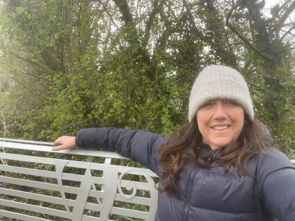 Julia Smith resting on Peter Clutterbucks new bench